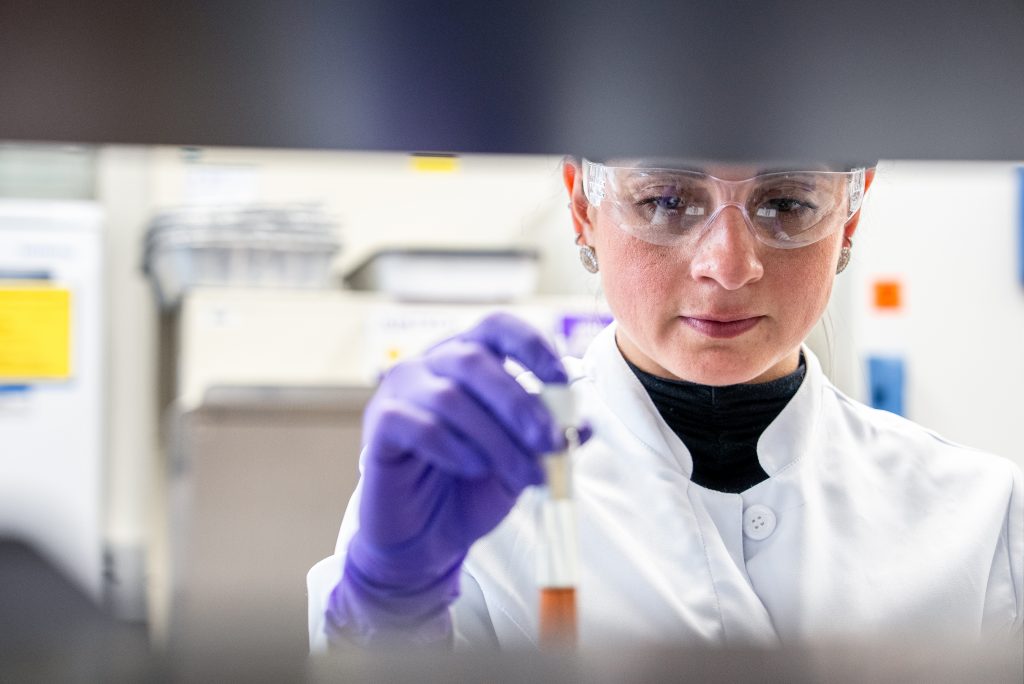 Scientist measuring liquid